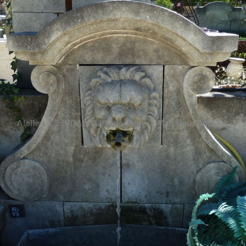 water fountain Alain Bidal : wall fountain with stone sculpture of a lion's head